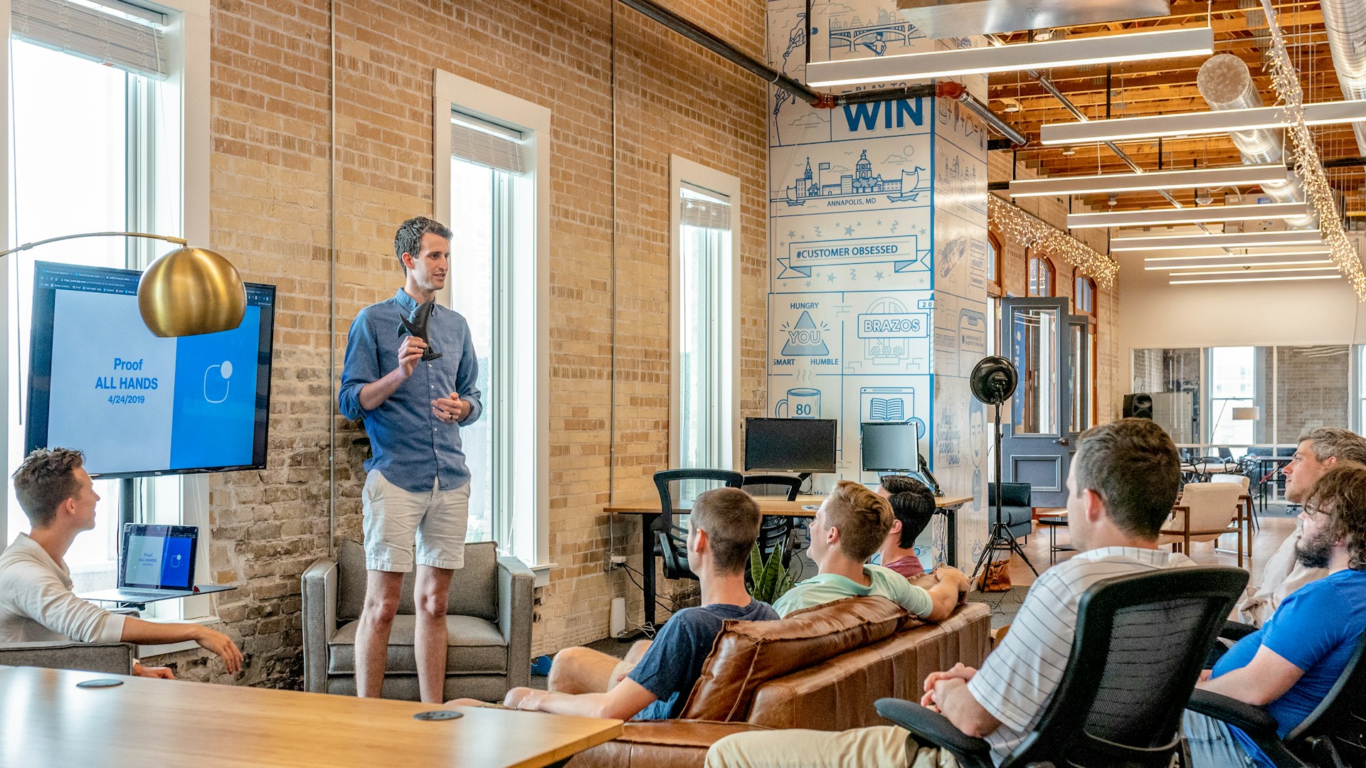 Team collaborating in a modern meeting space with a large display